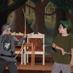 Two Highlands Latin School students perform a scene from Robin Hood in their costumes