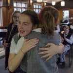 Highlands Latin School students hug in celebration in the cafeteria