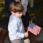 Little boy holds American flags